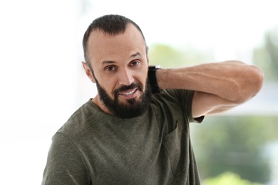 Photo of Portrait of handsome mature man on blurred background