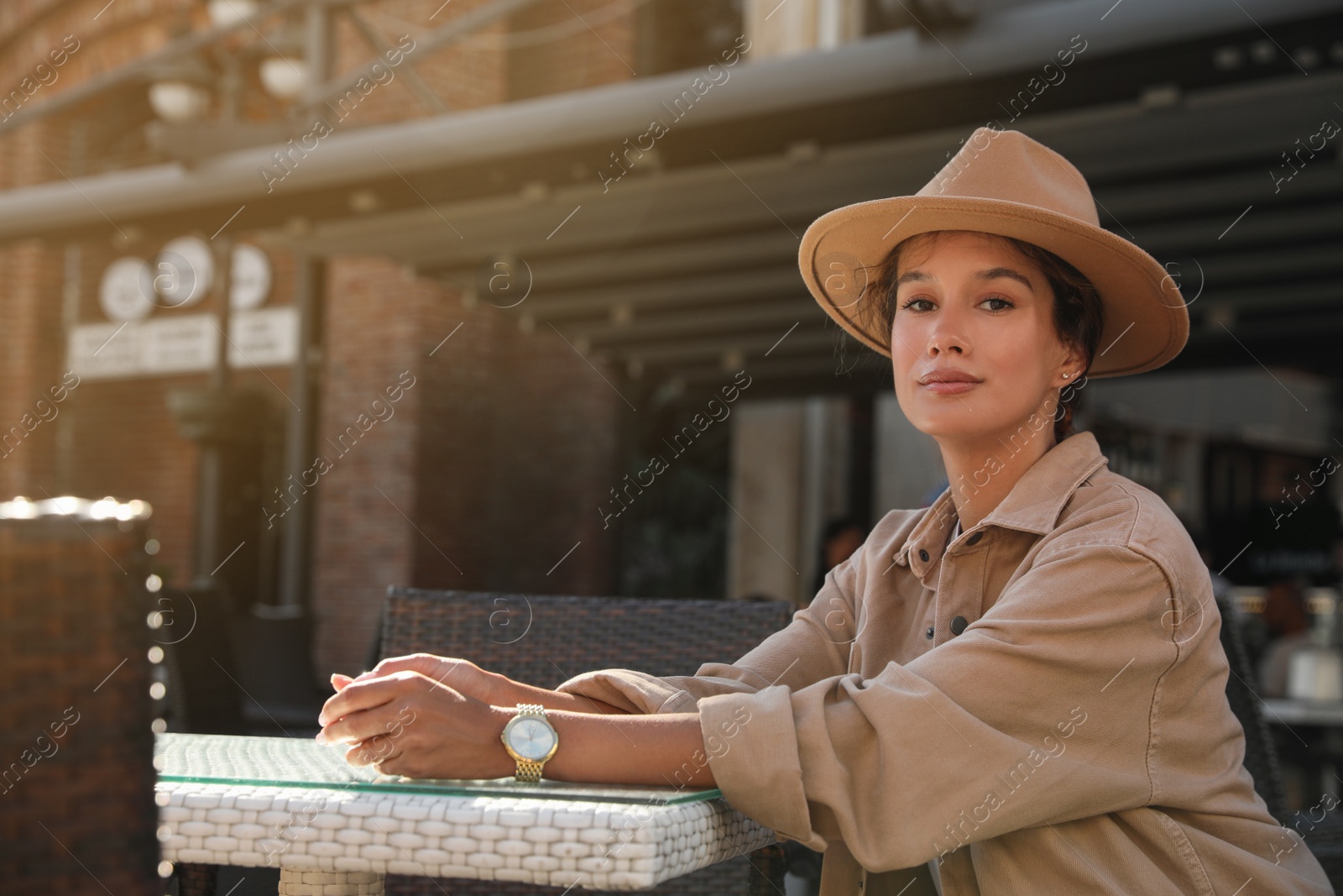 Photo of Portrait of beautiful young woman in outdoor cafe