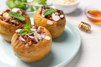 Photo of Baked apples on white wooden table, closeup