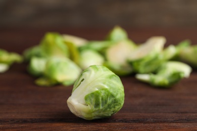 Photo of Fresh Brussels sprout on brown wooden table, closeup