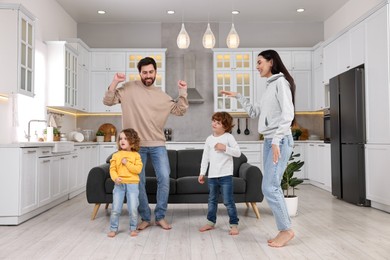 Photo of Happy family dancing and having fun at home