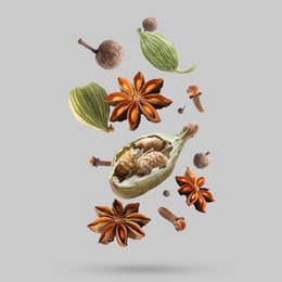 Image of Different spices falling on light grey background
