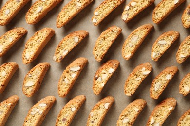 Photo of Traditional Italian almond biscuits (Cantucci) on parchment paper, flat lay