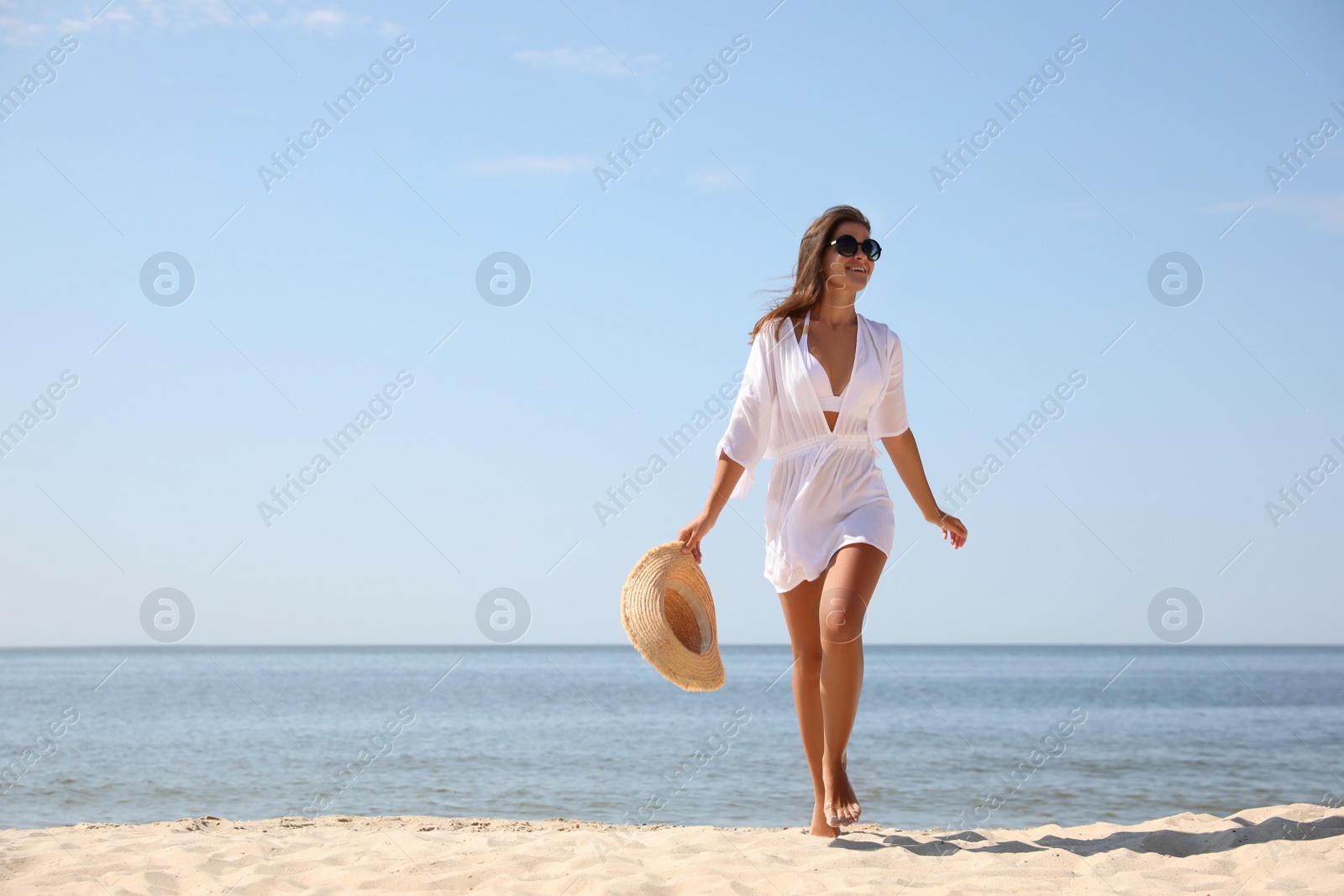 Photo of Young woman with beautiful body on sandy beach. Space for text