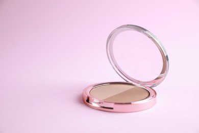 Photo of One face powder on pink background, space for text