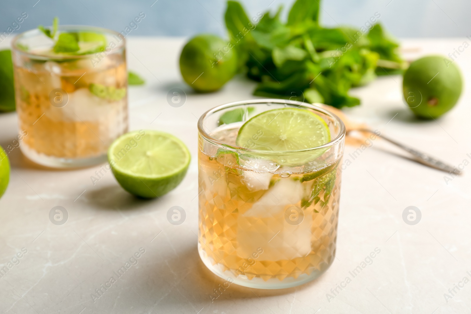 Photo of Composition with delicious mint julep cocktail on table