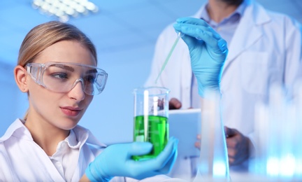 Photo of Female scientist working with sample in modern chemistry laboratory