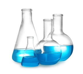 Photo of Laboratory glassware with liquid on white background. Solution chemistry