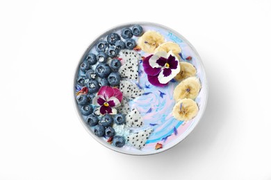 Photo of Delicious smoothie bowl with fresh fruits, blueberries and flowers on white background, top view