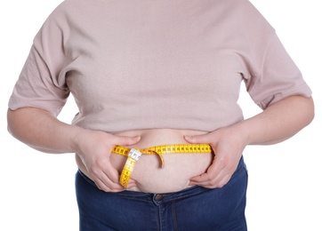 Photo of Overweight woman measuring waist with tape isolated on white, closeup