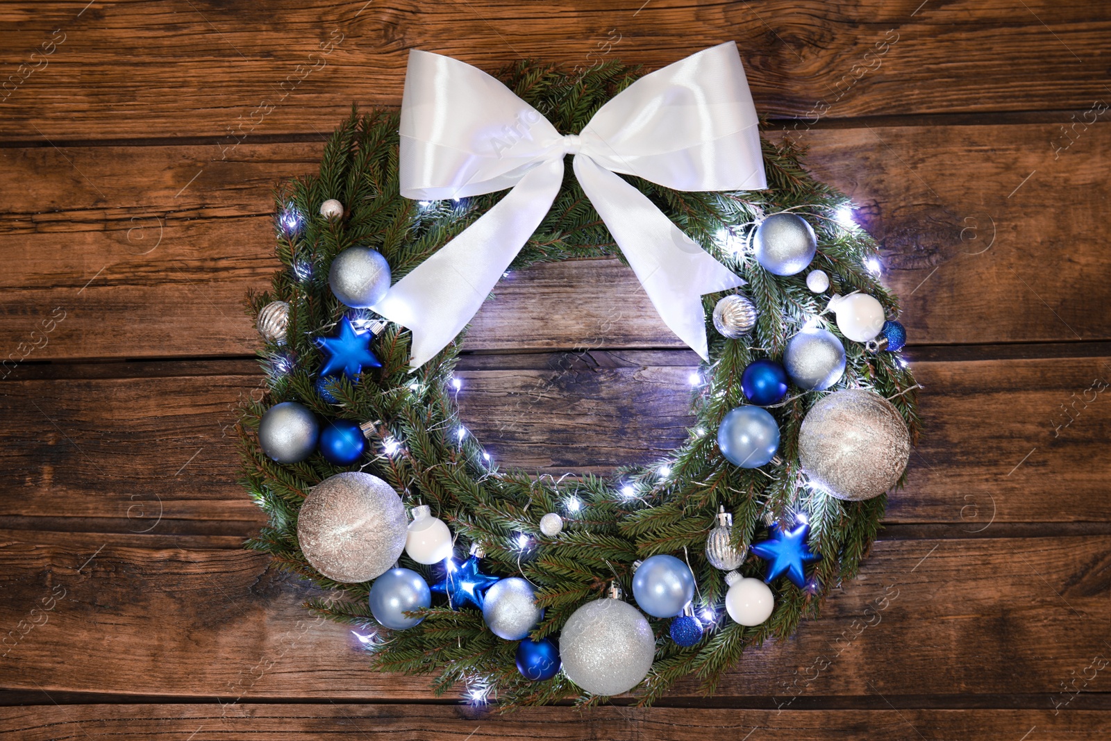 Beautiful Christmas wreath on wooden background, top view Photo of Beautiful Christmas wreath on wooden background, top view