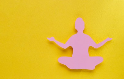 Photo of Woman`s health. Paper female figure on yellow background, top view with space for text