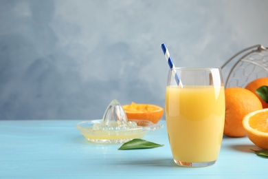 Photo of Composition with orange juice and fresh fruit on table, space for text