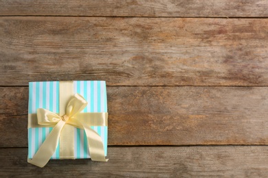 Photo of Elegant gift box with bow on wooden background, top view