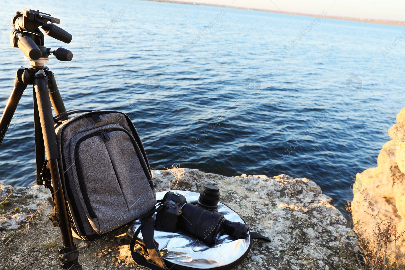 Photo of Professional photography equipment on rocky river coast