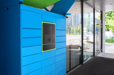 Parcel locker with many postal boxes near building outdoors