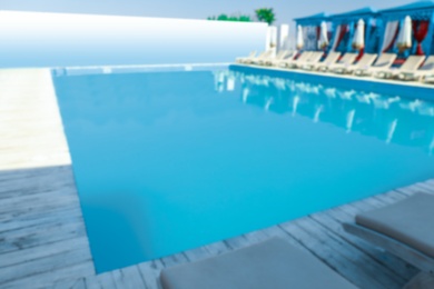 Blurred view of clean swimming pool on sunny day