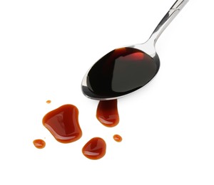 Photo of Tasty soy sauce in spoon isolated on white