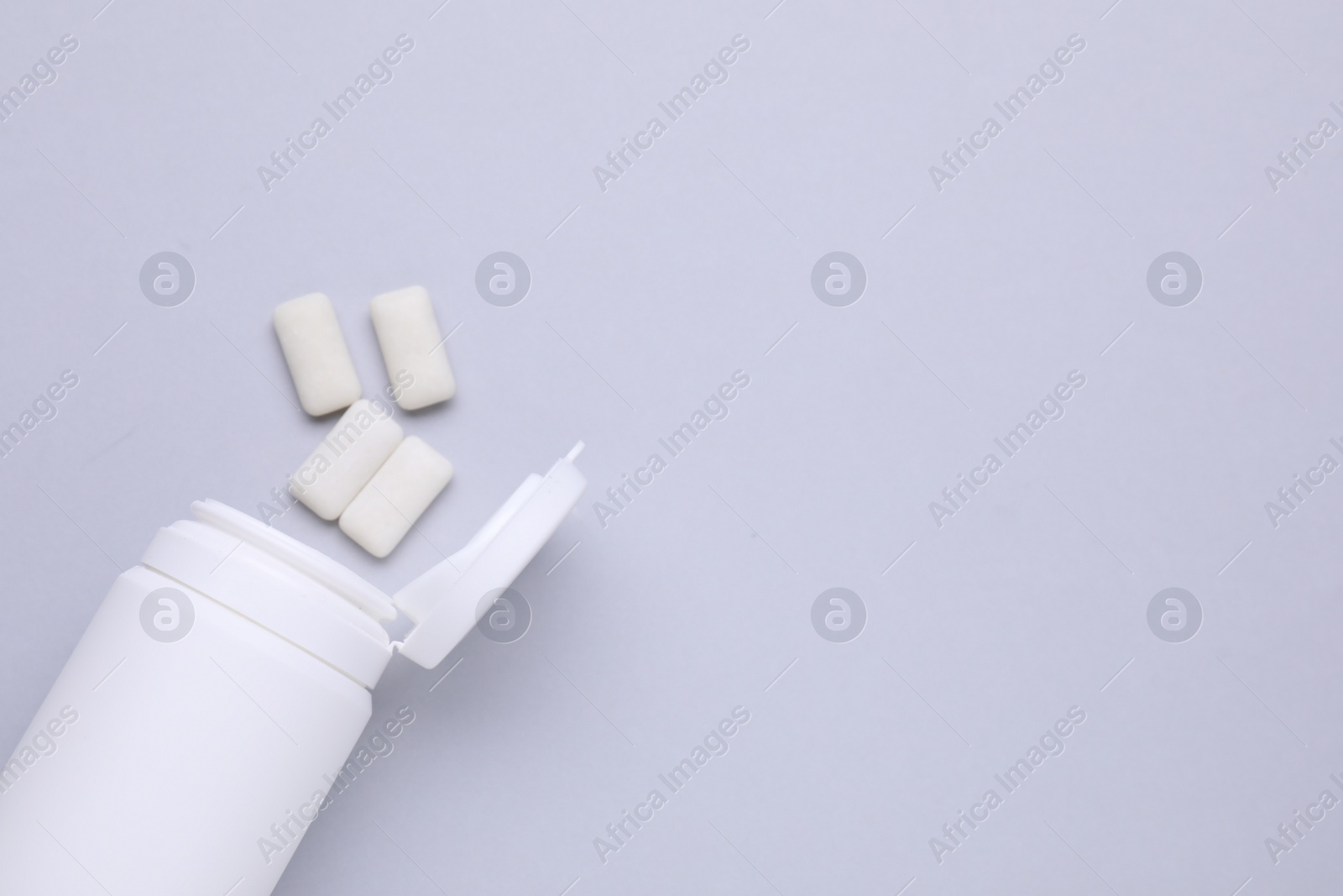 Photo of Jar with chewing gums on light grey background, flat lay. Space for text