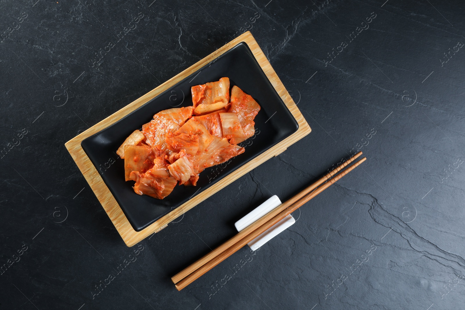 Photo of Delicious kimchi with Chinese cabbage served on grey table, flat lay
