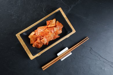 Photo of Delicious kimchi with Chinese cabbage served on grey table, flat lay