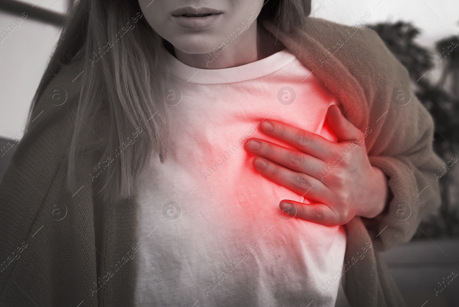 Image of Woman having heart attack at home, closeup