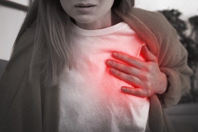 Image of Woman having heart attack at home, closeup