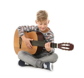 Photo of Little boy playing guitar isolated on white