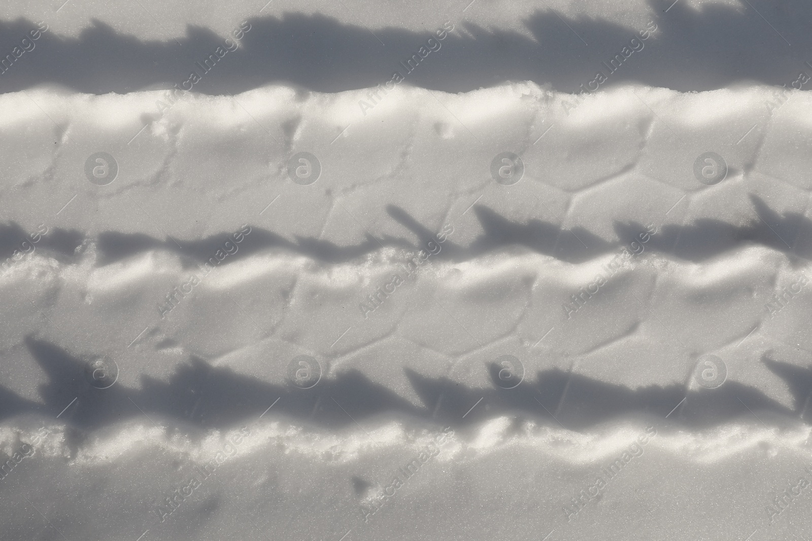 Photo of Car tire track on snow outdoors, top view. Winter season