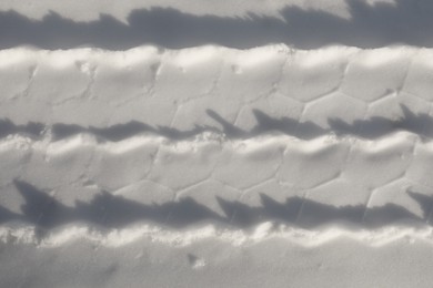 Car tire track on snow outdoors, top view. Winter season