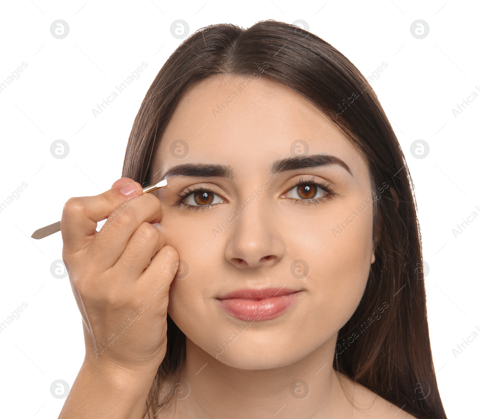 Photo of Young woman having eyebrow correction procedure on white background