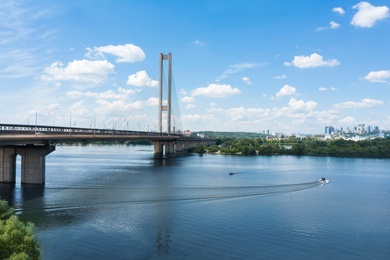 Image of Aerial view of modern bridge over river