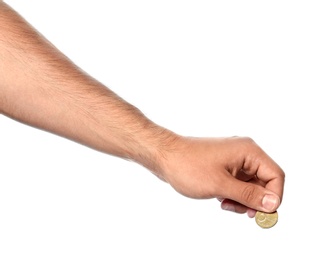 Young man holding coin on white background, closeup view
