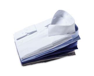 Photo of Stack of stylish shirts isolated on white. Dry-cleaning service