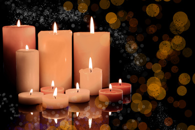 Image of Burning candles on dark background, bokeh effect