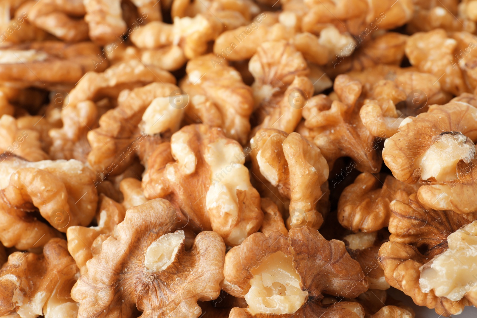 Photo of Pile of shelled walnuts as background, closeup