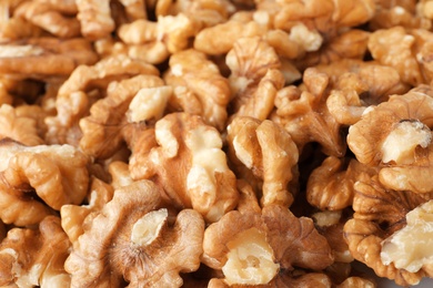 Photo of Pile of shelled walnuts as background, closeup