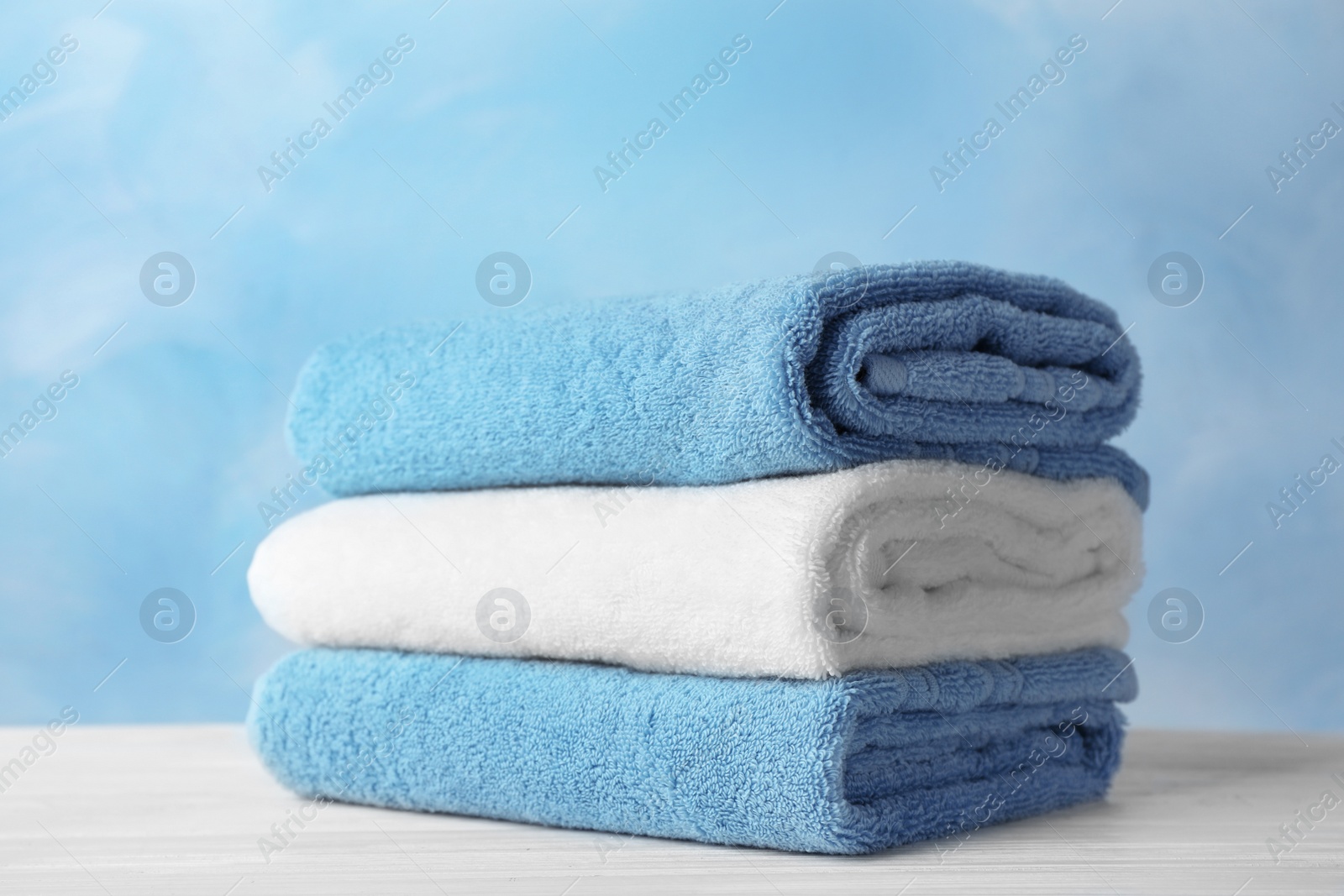 Photo of Stack of soft bath towels on table