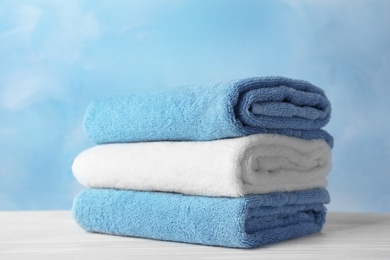 Photo of Stack of soft bath towels on table