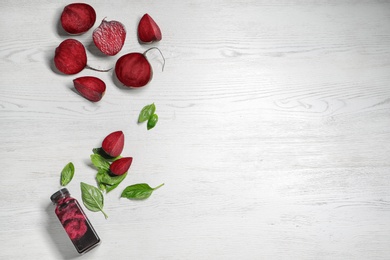 Flat lay composition with beet smoothie on white wooden background with space for text