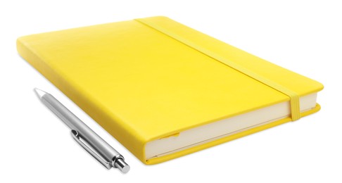 Photo of Closed yellow notebook with pen isolated on white
