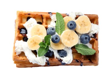Photo of Delicious Belgian waffles with blueberry, banana, whipped cream and chocolate sauce isolated on white, top view