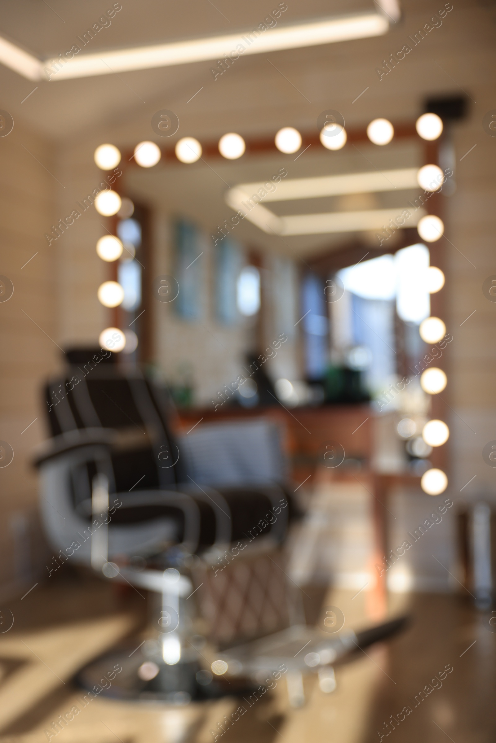 Photo of Blurred view of stylish barbershop interior with hairdresser workplace