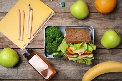 Flat lay composition with healthy food for school child on wooden background