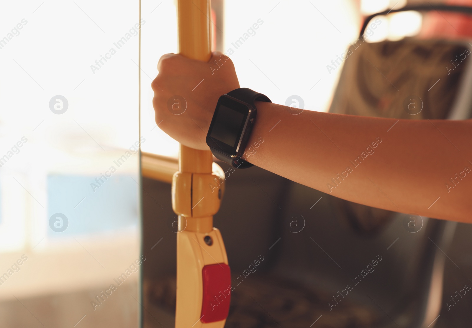 Photo of Young woman with smart watch in bus, closeup