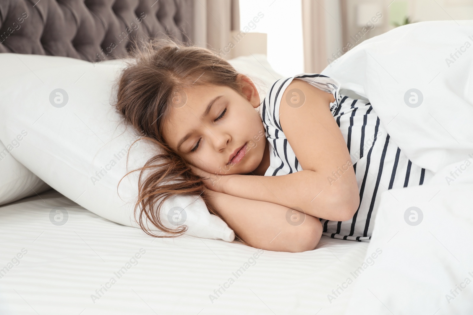 Photo of Cute little girl sleeping in comfort bed