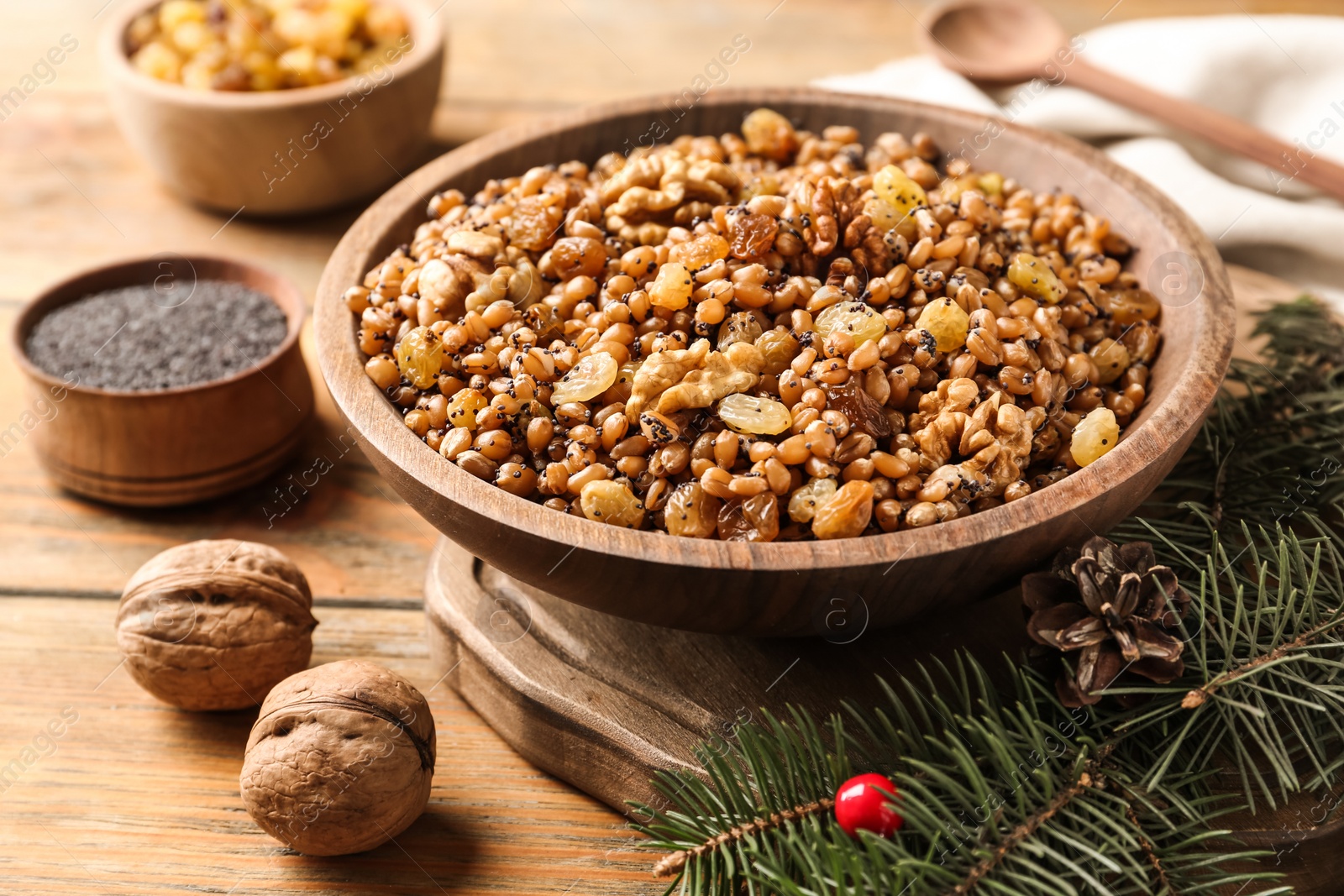 Photo of Traditional Christmas slavic dish kutia served on wooden table, closeup