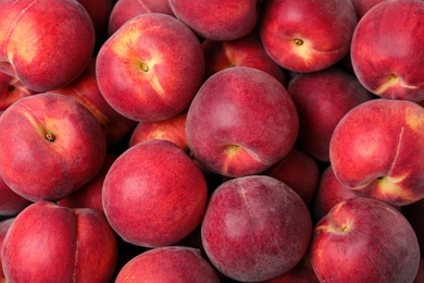 Photo of Delicious ripe peaches as background, top view