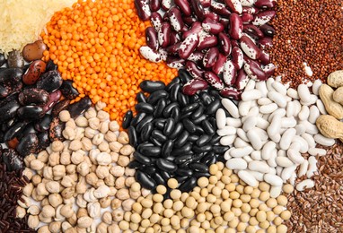 Photo of Various raw veggie seeds as background, top view
