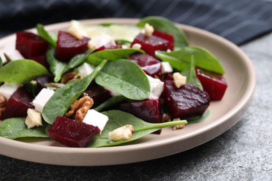 Delicious beet salad served on grey table, closeup